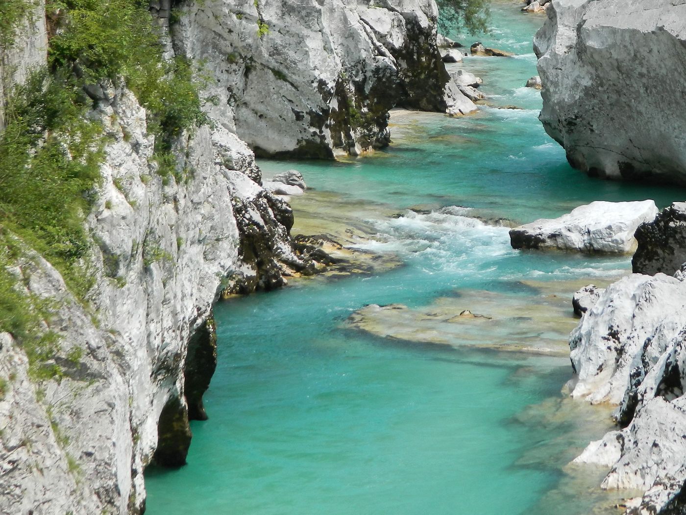 Turquoise water between white limestone boulders in the Great Soča Gorge